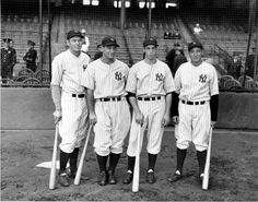 an old black and white photo of four baseball players