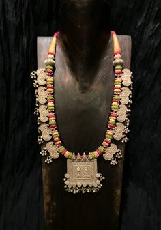 Get lost in the detail and unique beauty of antique silver Banjara beads strung onto a beautifully woven cord, handcrafted in India. All of our jewelry is one of a kind, handmade, and fair trade. A truly one of a kind piece, this necklace features the breathtaking intricacy of century old Banjara silverwork which is gracefully contrasted by the colorful and intricate woven cord they’re strung upon. The Banjara are one of the ancient nomadic tribes in India and have been known for centuries for t Antique Heavy Necklaces For Festival, Ornate Necklaces For Puja And Festivals, Antique Festival Necklaces With Intricate Design, Bulky Necklaces, Persian Textiles, Bollywood Brass Necklace With Intricate Design, Ornate Oxidized Necklace For Festivals, Tribes In India, Spain Art