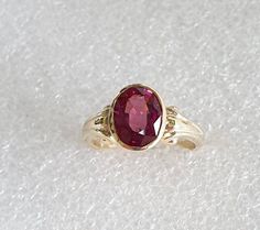 Antique style Gold and Rhodolite Garnet ring.  Genuine oval shaped Rhodolite Garnet set in 10 carat yellow gold. Garnet is AAA quality and measures 9mmsx7mms. Ring is made in 10 carat yellow gold. Ring size is K1/2 (Australian size) or 5 3/4 (US size). Ring is ready to ship in 1-2 working days.  We resize free of charge.  Please allow a couple of additional days for resizing. All my rings come in a velvet ring box.  I am highly conscious of environmental damage that extra packaging can create so Untreated Oval Ring Fine Jewelry, Untreated Oval Ring In Fine Jewelry Style, Victorian Ruby Ring With Oval Accent Stones, Oval Ruby Ring With Accent Stones In Victorian Style, Untreated Oval Rings Fine Jewelry, Victorian Style Oval Ruby Ring With Accent Stones, Antique Oval Gemstone Rings, Oval Ruby Cabochon Rings, Heirloom Oval Ruby Ring