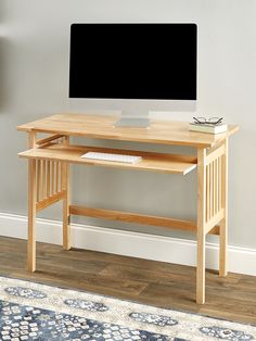 a wooden desk with a computer monitor on it