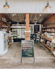 the inside of a store with lots of items on shelves and signs hanging from the ceiling