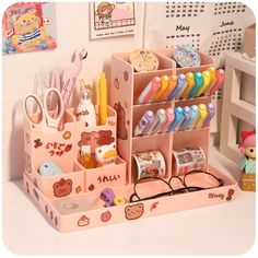 an assortment of items displayed in a pink toy store display case on a white table