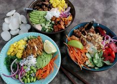 three plates filled with different types of food and chopsticks on the table next to each other