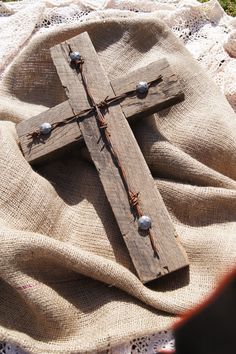 a wooden cross laying on top of a blanket