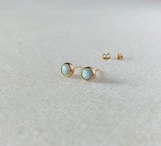 These solid 14k opal studs will be handmade to order.  Available in 4mm, 5mm and 6mm size.  Come with the tiny 14k gold ear backs.  The stones are man made, an imitation of white Australian opal. Solid gold sales are final, thank you! Minimalist Opal Earrings, Minimalist Opal Earrings For Gift, Minimalist Opal Earrings As Gift, White Opal Earrings, Opal Stud Earrings, Stud Earrings Gold, Opal Earrings Stud, Opal Studs, Earrings White