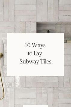 there is a sign that says 10 ways to lay subway tiles on the wall in this bathroom