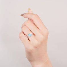 A Touch of Brilliance: The Tya Ring. This handcrafted sterling silver ring features a mesmerizing natural blue fire opal, its color captivating with every twist of your hand. A timeless piece that adds instant elegance to any look (sizes 3.5-14.25). ✦ DETAILS ✦ ✧ Handcrafted ✧ Natural opal and natural crystals ✧ Sizes 3.5-14.25 ✧ This ring set will arrive ready to gift in a Kherish velvet box. ✧ Due to the nature of the crystals, each piece may vary in color, size, shape, and contain natural inc Blue Opal Promise Ring, Elegant Blue Opal Promise Ring, Blue Opal Birthstone Ring In Sterling Silver, Elegant Blue Opal Birthstone Ring, Blue Opal Round Ring, Blue Round Opal Ring, Blue Opal Ring Birthstone Fine Jewelry, Blue Opal Birthstone Ring Fine Jewelry, Blue Sterling Silver Open Birthstone Ring