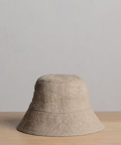 Linen Bucket Hat Natural Inspired by fisherman styles, our elevated take on the classic bucket hat is the summer’s definitive beach bag essential. 100% linen. Made in Portugal. | Jenni Kayne Women's Linen Bucket Hat Size Small/Medium