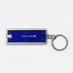 a blue key chain with the words greenacress on it