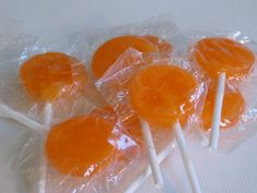 orange lollipops wrapped in plastic wrappers