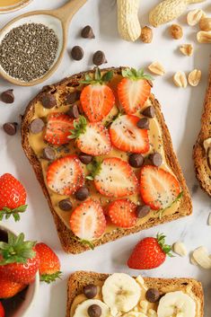 two slices of toast with strawberries, bananas and chocolate chips on them next to some nuts