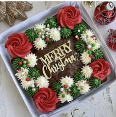 a cake decorated with red, white and green flowers