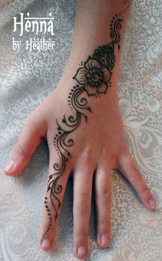 henna tattoo on the palm of a woman's hand