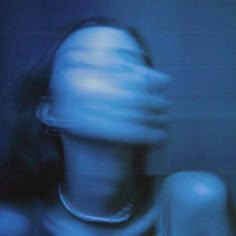 a blurry photo of a woman's face and neck