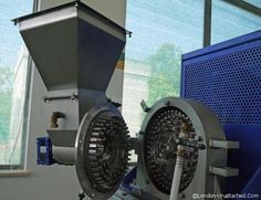 a machine that is sitting in front of a window with blue shutters on it