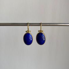 Striking blue Afghanistan lapis lazuli cabochons rest serenely within pristine gold bezels to make an effortlessly regal pairing. 18k yellow gold Lapis lazuli, 9.4ctw, 9mm x 13mm (3/8" x 1/2") Earrings hang 15/16" from the ear Each earring weighs 2.4g Blue Bezel Set Earrings For Formal Occasions, Yellow Gold Lapis Lazuli Cabochon Jewelry, Classic Lapis Lazuli Yellow Gold Jewelry, Classic Yellow Gold Lapis Lazuli Jewelry, Classic Yellow Gold Jewelry With Lapis Lazuli, Luxury Lapis Lazuli Cabochon Jewelry, Blue Lapis Lazuli Earrings For Formal Occasions, Formal Blue Lapis Lazuli Earrings, Elegant Lapis Lazuli Oval Cabochon Jewelry