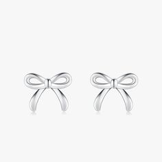 Discover the epitome of sweetness and style with our Charming Bowknot Hypoallergenic Stud Earrings. Perfectly capturing the essence of simplicity and elegance, these cute stud earrings feature an exquisite bowknot design that adds a touch of whimsy to any look. Crafted with care, these earrings are made from hypoallergenic materials, ensuring they're gentle on even the most sensitive ears. Each bowknot is meticulously designed to showcase a blend of classic charm and modern sophistication, making these earrings a versatile addition to any jewelry collection. Whether you're dressing up for a special occasion or adding a playful touch to your everyday ensemble, these bowknot studs are sure to become your go-to accessory. Not only do these earrings boast a timeless design, but they also prior White Gold Bow Earrings For Gift, Classic Bow Earrings For Anniversary, Dainty Silver Bow Earrings, Elegant Butterfly Knot Earrings As Gift, Elegant Butterfly Knot Earrings For Gift, Classic Bow Earrings For Party, Bow Earrings For Gift, Chic Silver Earrings With Decorative Bow, Chic Butterfly Knot Earrings As Gift