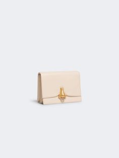 This shoulder bag is a luxurious accessory from the Schiaparelli brand, crafted in a beige hue. It is perfect for adding a touch of sophistication to any outfit. Designer Beige Top Handle Bag, Luxury Neutral Bags, Chic Rectangular Flap Bag For Everyday Luxury, Luxury Cream Tote Bag, Luxury Neutral Bags For Formal Occasions, Luxury Cream Satchel With Top Handle, Elegant Crossbody Satchel With Removable Pouch, Timeless Formal Shoulder Bag, Timeless Formal Flap Shoulder Bag