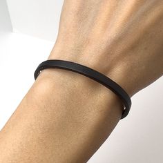 Leather Bracelet - Genuine Leather - Black Leather  - Black Bracelet - Stackable Bracelet - Leather Jewelry - Simple Leather Bracelet  Material: Genuine leather ( 4mm flat, black) and stainless steel clasp and elements. Free gift box: You will receive this bracelet in a beautiful gift box with cushion inside! Let me pleasantly surprise your loved ones on your behalf if it's a gift! If you need a special handmade jewelry - something unique or just have a question/comment just contact me via Etsy message. Love, Maria Everyday Black Bracelets With Wrist Strap, Modern Black Everyday Wristband, Classic Black Wristband For Everyday, Minimalist Black Leather Bracelet For Everyday, Adjustable Black Leather Bracelet, Minimalist Everyday Black Leather Bracelet, Adjustable Modern Black Wristband, Modern Adjustable Black Wristband, Adjustable Matte Black Modern Jewelry