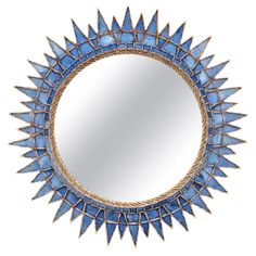 a round mirror with blue glass in the middle