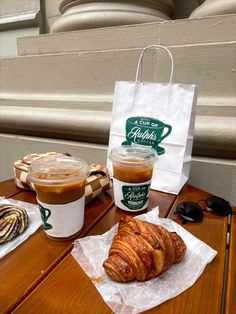 there is a croissant and coffee on the table