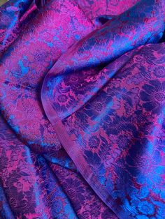 purple and blue fabric with floral designs on it