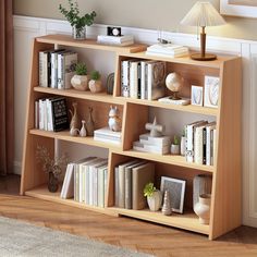 a bookshelf filled with lots of books next to a lamp on top of a hard wood floor