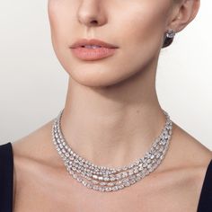 A covetable jewel with a larger than life shine, this multi-layered diamond necklace offers an allure that cascades gracefully across the neckline. Its multiple rows of diamonds in different cuts provide a full-coverage sparkle. Showcasing X carats of diamonds, indulge in a showstopping piece that will enduringly stand out and leave a lasting impression. Luxury Timeless Diamond Necklace With Halo Setting, Luxury Classic Diamond Necklace With Curb Chain, Luxury Classic Diamond Necklace With Cable Chain, Luxury Heirloom White Gold Necklaces, Diamond Layered Necklace, Luxury Fine Jewelry Drop Necklace With Single Cut Diamonds, Luxury White Fusion Jewelry, Luxury Cushion Cut Engagement Necklace, Luxury Three Stone Diamond Necklace