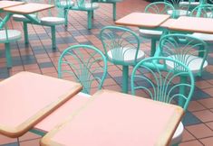 the tables and chairs are all pastel pink and blue, with matching green tops