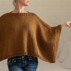 a woman wearing a brown knitted shawl