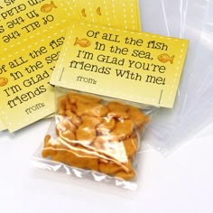 three small bags filled with food sitting on top of a table