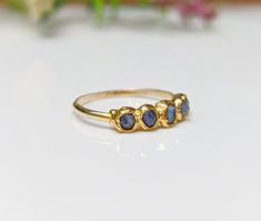 What's not to Love about this raw Sapphire Eternity ring ! Our September Birthstone ring features a row of 5-7 small raw blue Sapphires uniquely handcrafted on a Solid 14k Gold filled band. This lovely raw multi-stone ring will make a unique wedding band, but can also be offered as a gift on special occasions such as a birthday, anniversary, Mother's Day, Christmas, or Valentine's Day and would surely make a lovely alternative engagement ring! ❣T H E ∙ S M A L L ∙ D E T A I L S• 5-7 raw blue Sap Raw Sapphire, September Birthstone Ring, Birthstone Ring Mothers, Sapphire Eternity Ring, Unique Wedding Band, Raw Stone Jewelry, September Birthstone Rings, Alternative Engagement Ring, Mom Ring