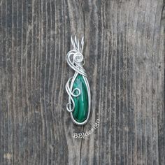 Wire wrapped Malachite pendant. Stone:  Malachite Wire:  sterling silver filled Height: 1 5/8 inches / 4.2 cm Width:  1/2 inches / 1.2 cm Weight: 0.17 oz / 4.7 g Chain:  sterling silver with lobster claw clasp If you choose 0 (zero) inch chain, pendant ships without a chain. For shipping to countries not listed, please contact me for prices. Hand Wrapped Green Sterling Silver Jewelry, Container Ideas, Malachite Pendant, Sterling Silver Wire Wrap, Cabochon Pendant, Wrapped Jewelry, Wire Art, Chain Pendant, Necklace Sterling Silver