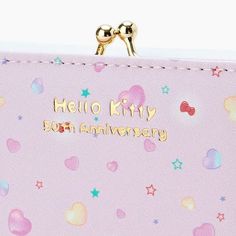 a pink purse with hearts and stars on it that says hello kitty 30th anniversary in gold lettering