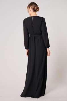 Warm and inviting, the Wholehearted Maxi Dress is a perfect combination of modest and sultry. Long balloon sleeves frame a surplice neckline separated by a tie at the waist, creating a forgiving faux wrap. The skirt maintains an airy and flowy shape that trails behind as you walk down the aisle. - Chiffon- Faux wrap- Keyhole- Elastic waist- Comes in 14 ColorsSize + Fit - Model is 5'9" and wearing size XS- Measurements taken from size S - Chest: 35"- Length: 63 1/4" Fabric Self: 100% PolyesterLin Modest V-neck Formal Dress, Fitted Maxi Length V-neck Wedding Dress, Modest Solid Color Maxi Dress For Evening, Modest V-neck Maxi Dress For Party, Modest Fitted V-neck Maxi Dress, Modest Floor-length Maxi Dress For Formal Occasions, Fitted V-neck Surplice Neckline Dress For Wedding, Modest V-neck Party Dress, Modest Solid Color Maxi Dress For Wedding