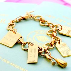 GOLD CHARM BRACELET WITH 12 LUGGAGE TAG CHARMS (MINI PLANE SHIPS JUNE) - JET SET CANDY  (4401092821080) Crab Fries, Best Champagne, Travel Charms, Grand Daughter, Gold Charm Bracelet, Charms Bracelet, Gifts Cards, Champagne Gold, Luggage Tag