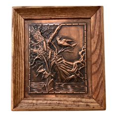 a wooden frame with an image of a bird and tree