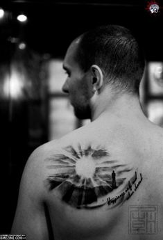 a man with a tattoo on his back