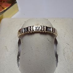 This Simple Estate Band Features 3) Natural Round Diamonds, All Reset Into The Gold With 4 Prongs Each, And A Double Bar & Star Like Design Between Each Diamond. The Band Measures Aprox 2.8mm In Width, And Weighs Aprox 2.228 Grams Of Solid (Stamped Bonafide 14kt Inside Shank) 14kt Yellow Gold. This Estate Diamond Bar Band Is Priced In Our Store At $3499.00. Finger Size 6 1/2 (This Ring Can Be Sized By Your Local Jeweler, At Your Cost, We Do Not Size, Sorry) *All Of Our Estate Jewelry Sold As Is Diamond Bar, Selling Jewelry, Womens Jewelry Rings, Estate Jewelry, Round Diamonds, Yellow Gold, Women Jewelry, Band, Women Shopping