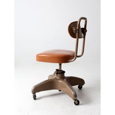 an office chair with wheels and a brown leather seat on the back, against a white background