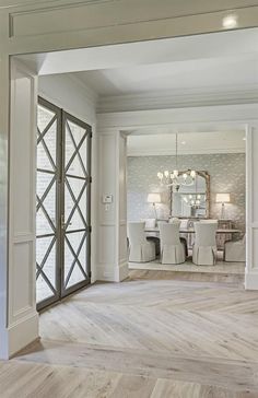 an open door leading to a formal dining room