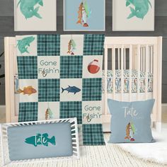 a baby's room with blue and green wallpaper, crib bedding, and pillows