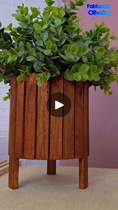 a wooden planter with green plants in it