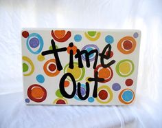 a sign that says time out on it with colorful circles and dots in the background