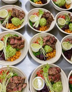 many white plates with different types of food on them, all containing meat and veggies