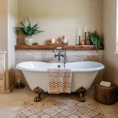 a bathroom with a claw foot tub and candles