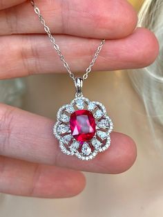 "3.50 carats, natural red Ruby pendant Necklace, emerald cut, set in 925 Sterling Silver, with 16-18\" inches adjustable chain. Stone size: 10mmx8mm. Pendant size: 1\"x0.65\" inches, approximately, including bail." Red Emerald Cut Fine Jewelry, Red Emerald-cut Fine Jewelry, Red Emerald Cut Diamond Jewelry, Dazzling Lab-created Ruby Jewelry As Gift, Dazzling Lab-created Ruby Jewelry For Gift, Red Diamond Radiant Cut Jewelry, Red Emerald-cut Sterling Silver Jewelry, Red Radiant Cut Diamond Jewelry, Dazzling Red Jewelry Gift