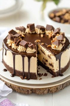 a chocolate cake with white frosting and chopped walnuts on top, cut in half