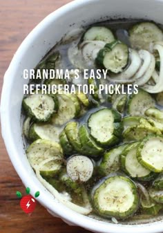 a white bowl filled with sliced cucumbers on top of a wooden table and text grandma's easy refrigerator pickles