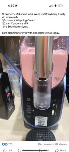 a pink drink being poured into a blender